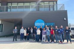 Citizens academy 2023 standing in front of addison airport sign
