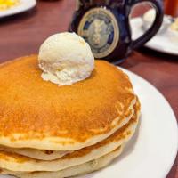 Stack of pancakes with a scoop of butter on top