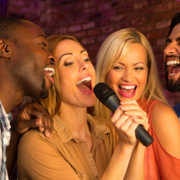 people singing into a microphone
