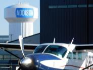Cessna Caravan parked with water tower in the background