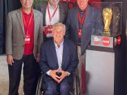 Texas Governor Greg Abbott and Mayor Joe Chow standing next to the FIFA Soccer trophy