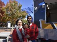 Family standing by food truck