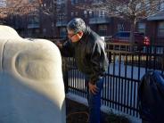 Artist Eliseo carving his name in the Let's Play sculpture
