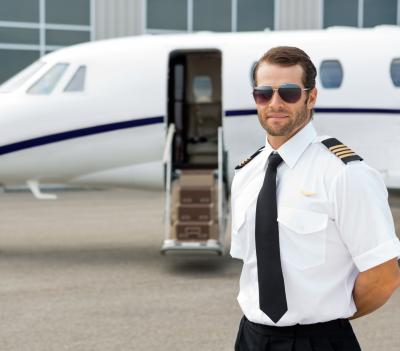 Pilot Standing Next to Airplane