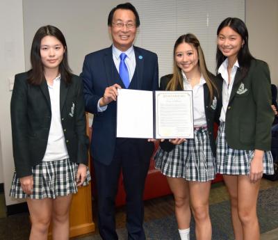 Madeleine Chen, Ariana Wang, and Kaelyn Lee accept VisionsForConfidence Proclamation