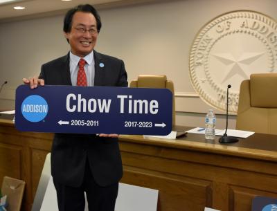Mayor Chow holding a street sign that says Chow Time