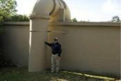 Celestial Pump Station: Man standing next to very large pipe