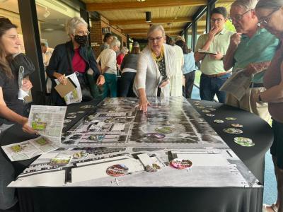 Group of people standing around a map on a table