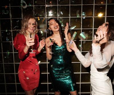3 women celebrating nye in party attire