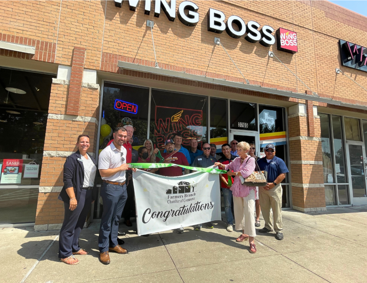 Ribbon Cutting Photo in front of Wing Boss